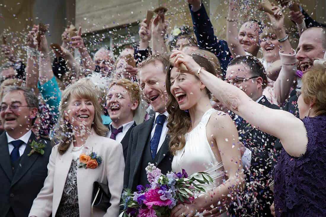 explosion of confetti on bride and groom